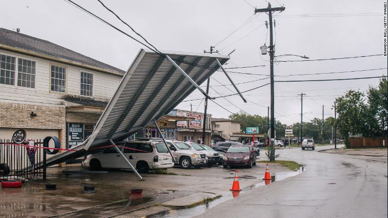 A carport hangs from power lines Tuesday after Tropical Storm Nicholas moved through Houston.