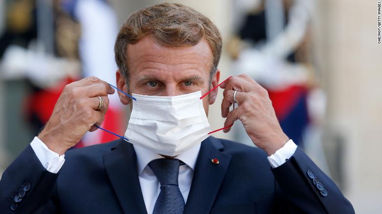 Macron adjusts his face mask during a press conference at the Elysee Palace in Paris on September 6.