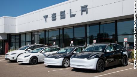 Cars at charging stations at a Tesla car dealership in Maplewood, Minnesota on June 13, 2021.