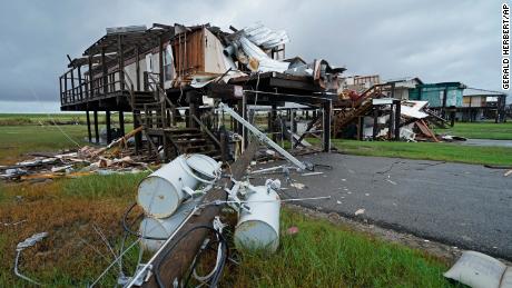 Storm clouds from Nicholas are seen Tuesday behind homes destroyed by Hurricane Ida in Pointe-aux-Chenes, Louisiana.