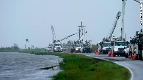Utility crews replace power poles destroyed by Hurricane Ida in Pointe-aux-Chenes, Louisiana, on September 14, 2021.