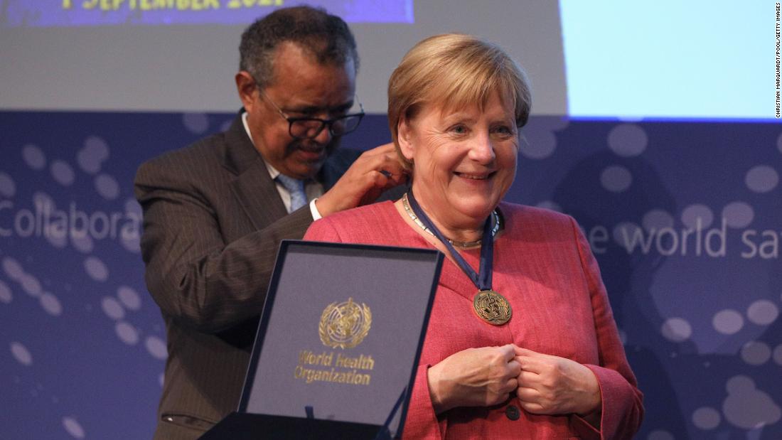 Merkel receives a medal from Tedros Adhanom Ghebreyesus, director-general of the World Health Organization, during the opening of the WHO Hub for Pandemic and Epidemic Intelligence in Berlin in September 2021. The new center&#39;s purpose is to better track world health threats and help prevent future ones.