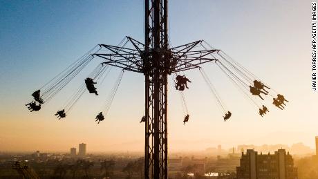 People are seen at an amusement park attraction in Santiago, Chile, on July 30, 2021.