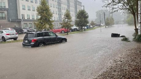 A car is passes through flooding in Baton Rouge, Louisiana, on September 15, 2021. 