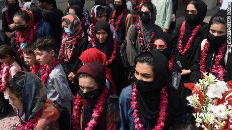 TOPSHOT - Members of Afghanistan&#39;s national girls football team arrive at the Pakistan Football Federation (PFF) in Lahore on September 15, 2021, a month after the hardline Taliban swept back into power officials said. (Photo by Arif ALI / AFP) / The erroneous mention[s] appearing in the metadata of this photo by Arif ALI has been modified in AFP systems in the following manner: [team arrive] instead of [dressed in burqas]. Please immediately remove the erroneous mention[s] from all your online services and delete it (them) from your servers. If you have been authorized by AFP to distribute it (them) to third parties, please ensure that the same actions are carried out by them. Failure to promptly comply with these instructions will entail liability on your part for any continued or post notification usage. Therefore we thank you very much for all your attention and prompt action. We are sorry for the inconvenience this notification may cause and remain at your disposal for any further information you may require. (Photo by ARIF ALI/AFP via Getty Images)