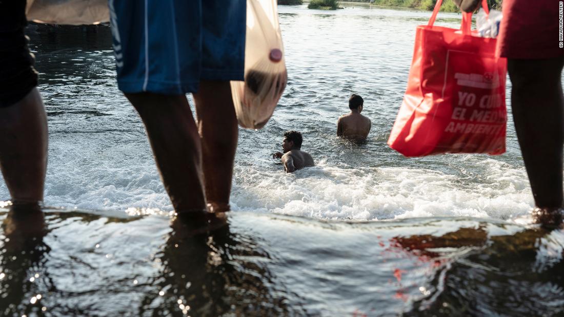 Migrants seeking asylum in the United States bathe in the Rio Grande near the International Bridge on September 17.