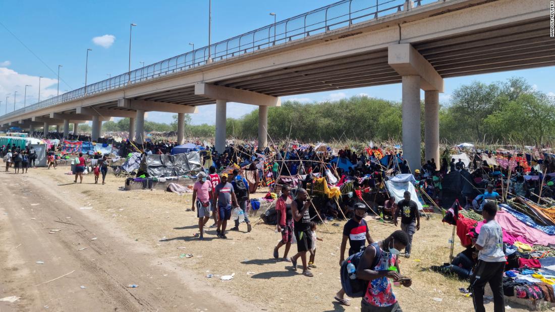 In this photo provided by law enforcement, migrants take shelter under the Del Rio International Bridge that connects Del Rio with Ciudad Acuña on September 18.