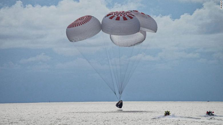 The SpaceX Crew Dragon capsule splashes down into the ocean off the coast of Florida.