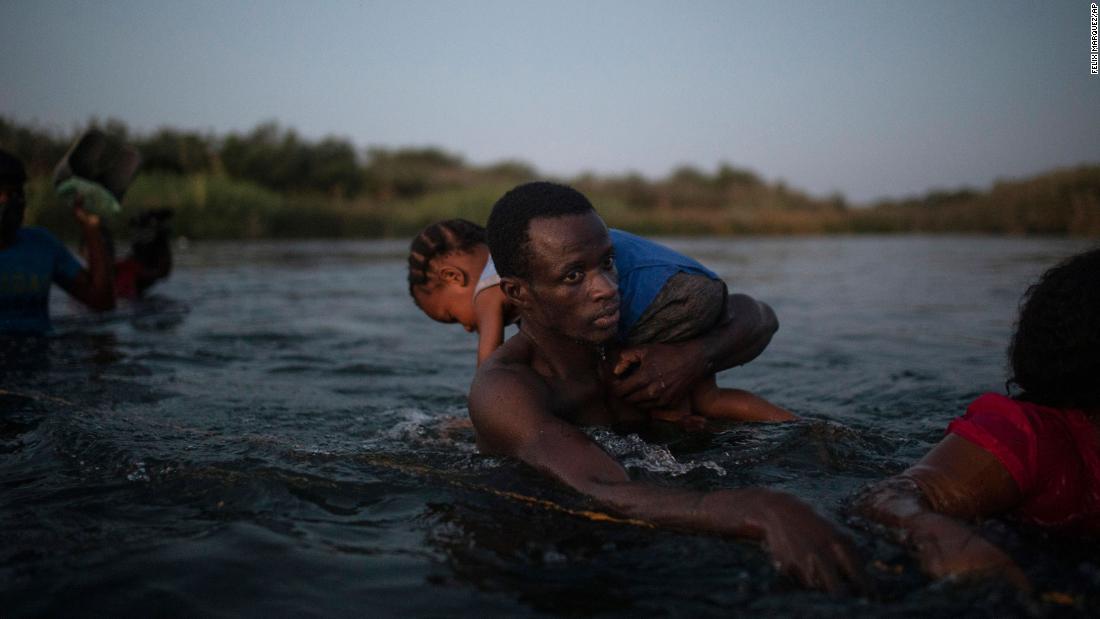 Migrants wade across the Rio Grande from Del Rio, Texas, to Ciudad Acuña, Mexico, September 19. 