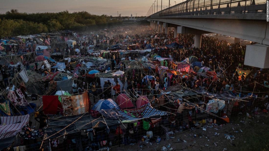 Migrants wait to be processed near the Del Rio International Bridge in Del Rio, Texas, on Sunday, September 19.