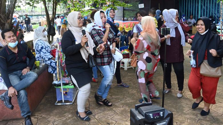 A group of residents gathering for an outdoor karaoke session at a park on the outskirts of Jakarta, Indonesia, on September 19.