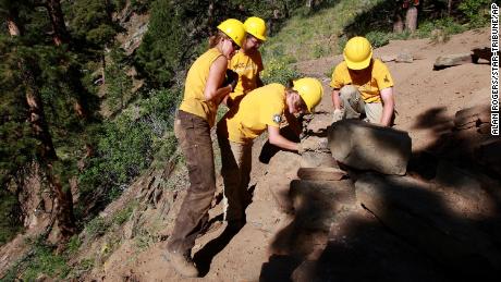 Members of the Wyoming Conservation Corps rebuild a stone retaining wall in June 2013, in Casper, Wyoming.  A team of 8 spent 10 days making improvements and repairs to the Bridle Trail at Casper Mountain.