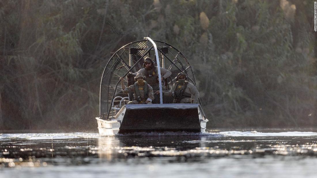 US Border Patrol agents watch migrants cross the Rio Grande on September 20.