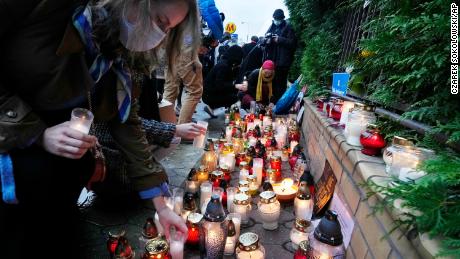 Warsaw residents light candles at the national border guard headquarters, in a sign of mourning for the migrants found dead over the weekend.