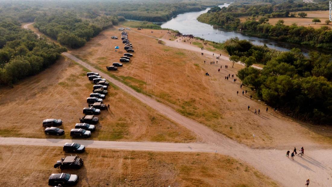 Texas governor approves miles-long steel barrier of police vehicles to deter the more than 8,000 migrants in Del Rio