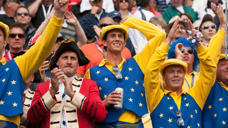 European team fans cheer at the first hole during the morning foursome matches for the 39th Ryder Cup in Illinois.