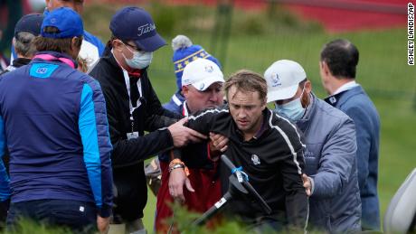 Felton is helped off the course on the 18th hole at Whistling Straits.