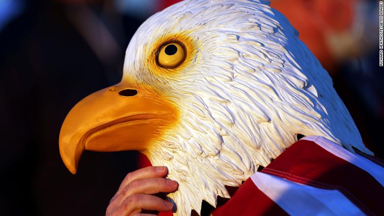 A fan of Team US wears a bald eagle mask during Friday morning Foursome matches.
