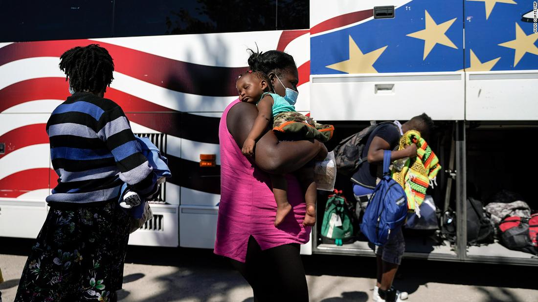 Migrants prepare to board a bus toward Houston provided by a humanitarian organization after they were released from US Customs and Border Protection custody in Del Rio on Thursday, September 23.