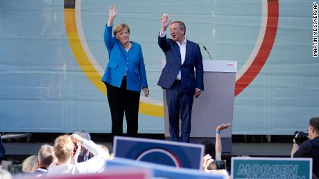 Chancellor Angela Merkel and Armin Laschet, top candidate for the upcoming election, wave to supporters at the final election campaign event of the Christian Democratic Party, CDU, in Aachen, Germany, on Saturday.