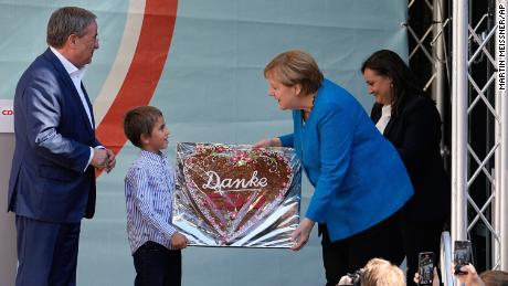 Chancellor Angela Merkel is given a traditional gingerbread reading &quot;Thanks CDU&quot; beside Armin Laschet, top candidate for the upcoming election, left, at their party&#39;s final campaign event in Aachen on Saturday.