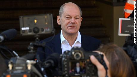 Olaf Scholz speaks to reporters after voting at a polling station in Potsdam, eastern Germany, during general elections on September 26.
