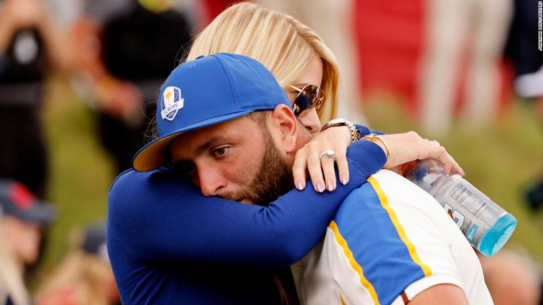 Team Europe&#39;s Jon Rahm is consoled by his wife Kelley Cahill after Team US win The Ryder Cup.