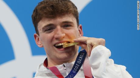 Matty Lee poses with his gold medal at the Tokyo Olympics. 