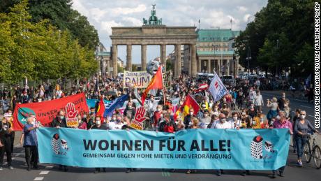 At a protest against high rents in Berlin, demonstrators hold a banner with the inscription &#39;Wohnen fuer Alle!&#39; (Housing for All) on September 11, 2021. 