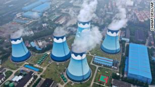 Steam billows out of the cooling towers at a coal-fired power station in Nanjing, China.