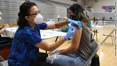 Nurse Susanna Bryan administers a dose of the Pfizer Covid-19 vaccine at a vaccination clinic at Winter Springs High School in Winter Springs, Florida on September 11.