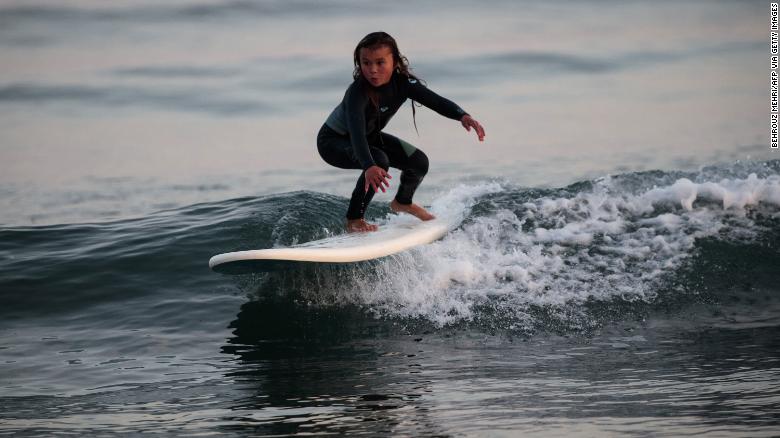 Brown surfs at a beach in Takanabe town, Miyazaki prefecture.