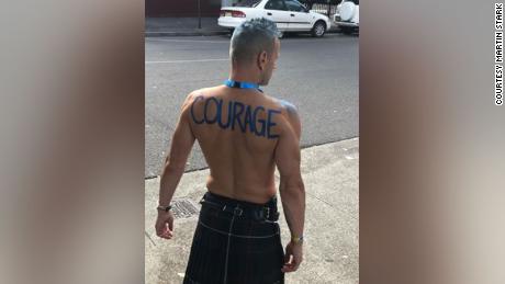 Stark with the word &quot;courage&quot; on his back before marching in the Sydney Gay and Lesbian Mardi Gras in March 2019. He now has the word tattooed on his back.