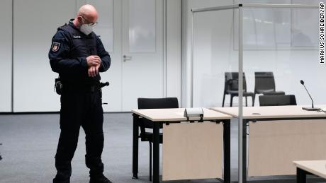 A judicial officer at the court room in Itzehoe looks at his watch before the trial of a 96-year-old former secretary at the Stutthof concentration camp was due to start.
