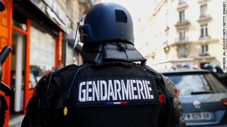A French gendarme, or military police officer, stands during a demonstration against  the French government in Paris on July 24, 2021.