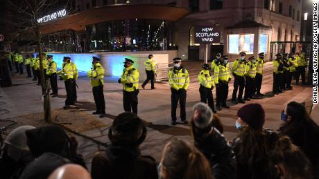 Police officers form a cordon at New Scotland Yard, the headquarters of the Metropolitan Police Service, in central London on March 14, 2021 as protesters called for greater public safety for women in the wake of Sarah Everard&#39;s murder. 