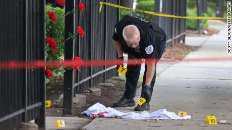 Police investigate a crime scene where three people were shot -- one fatally -- in the Bridgeport neighborhood on June 23, 2021, in Chicago. The city has recorded 756 homicides so far this year.