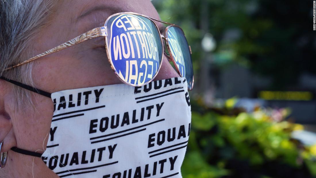 A sign advocating for legal abortion is reflected in a protester&#39;s eyeglasses in Washington, DC.