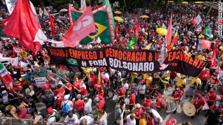 Demonstrators rally alongside a banner with a message that reads in Portuguese: &quot;vaccine and jobs, democracy and impeachment, Bolsonaro get out&quot;, during a protest against Brazilian President Jair Bolsonaro in Sao Paulo, Brazil, on October 2.