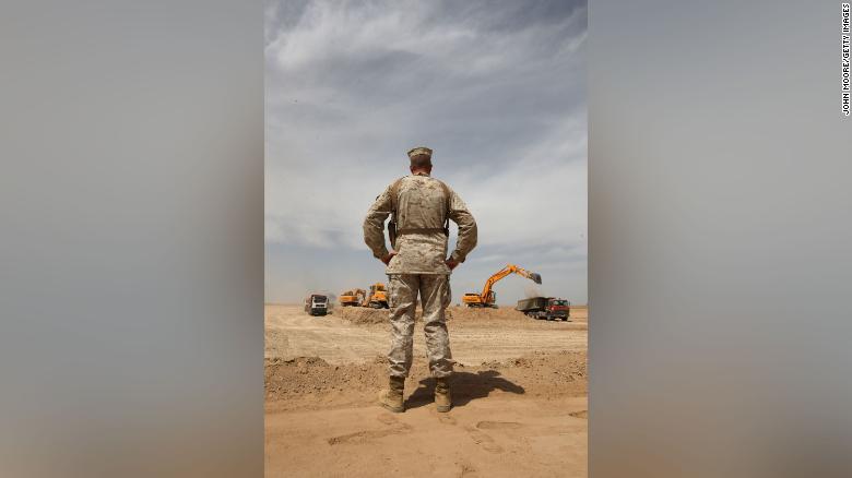 US Marine MSgt. Charles Albrecht watches a construction crew working on a massive new base at Camp Letherneck, Helmand province, in March 2009.