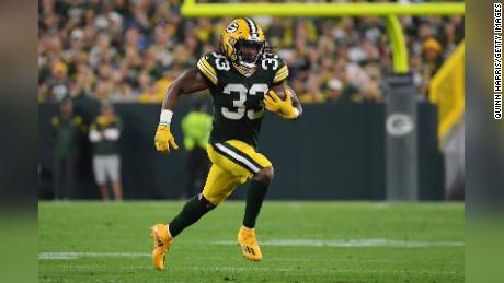 Aaron Jones #33 of the Green Bay Packers runs against the Detroit Lions during the first half at Lambeau Field on September 20, 2021 in Green Bay, Wisconsin. 