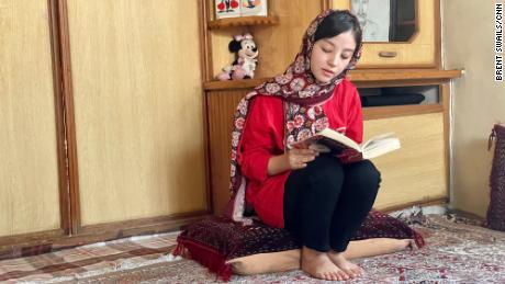 Sanam, 16, barred by the Taliban from going to school, continues her studies from home.