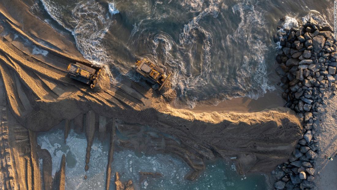 Heavy equipment is used to block oil from reaching the Talbert Marsh area.