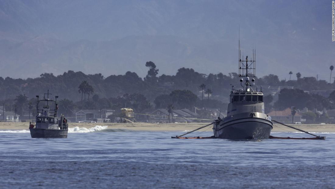 Oil-skimming boats work the waters off the coast of Huntington Beach on October 3.