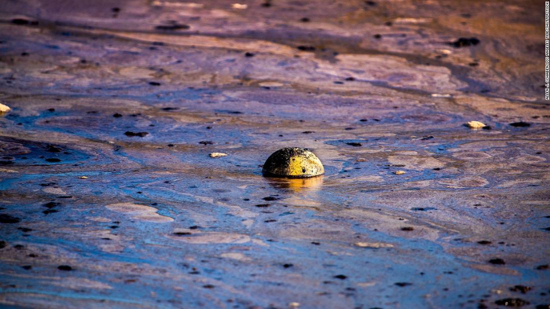 A ball floats in oil that had washed ashore on October 3.