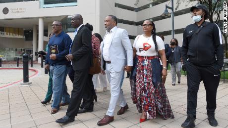 Attorney Ben Crump, second from left, walks with Ron Lacks, left, Alfred Lacks Carter, third from left, both grandsons of Henrietta Lacks, and other descendants of Lacks, whose cells have been used in medical research without her permission, outside the federal courthouse in Baltimore on Monday.