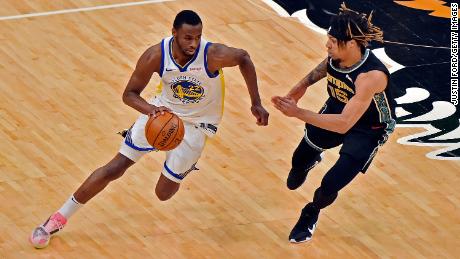 Andrew Wiggins #22 of the Golden State Warriors handles the ball against Brandon Clark #15 of the Memphis Grizzlies during the second half at the FedExForum on March 19, 2021 in Memphis, Tennessee.  Wiggins recently received a vaccine after requesting an exemption on religious grounds.