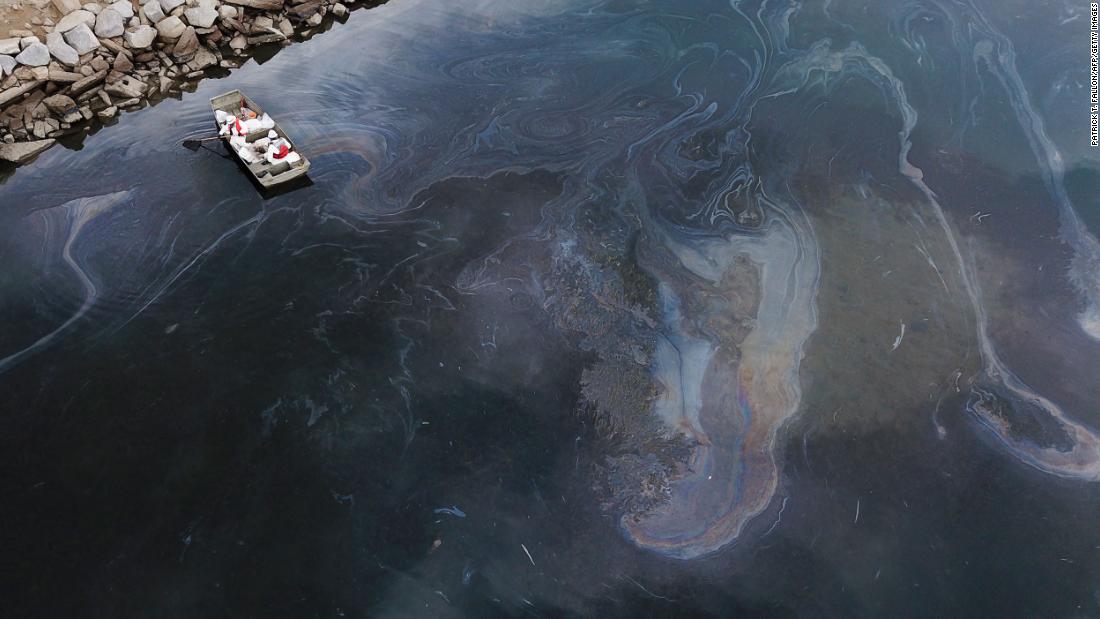 This aerial photo, taken on October 4, shows environmental response crews cleaning up oil that flowed near the Talbert Marsh in Huntington Beach.