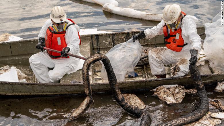 Patriot Environmental employees work to clear oil from the surface of the water inside Talbert Marsh in California on Monday, October 4.