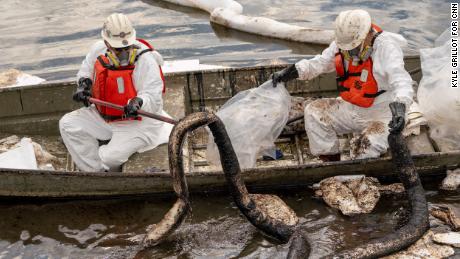 Patriot Environmental employees work to clear oil from the surface of the water inside Talbert Marsh in California on Monday, October 4.